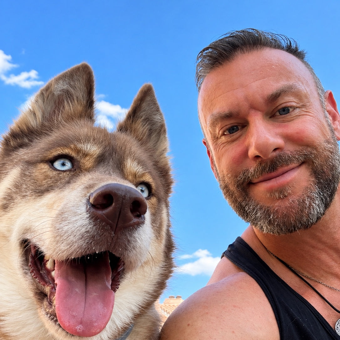 Adam with Simba outdoors under a blue sky