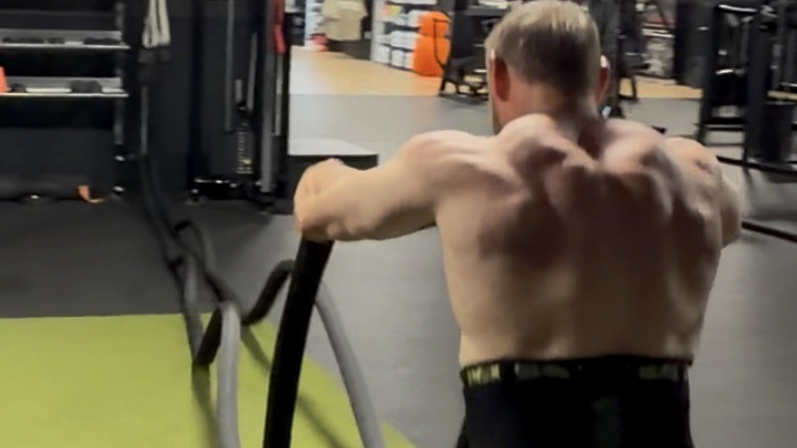 Adam demonstrating battle rope conditioning in the gym